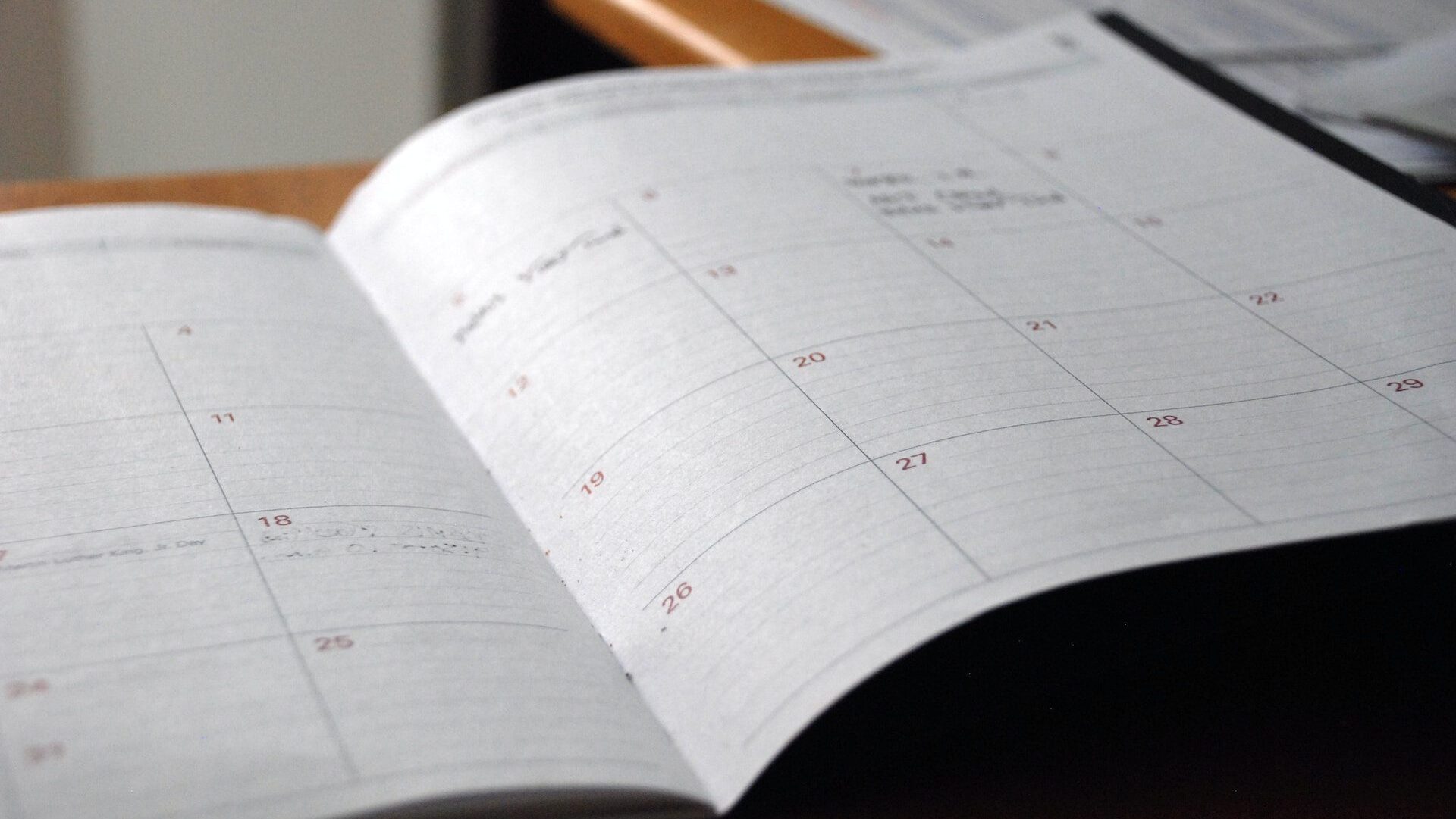 An open planner with blank entries on the days