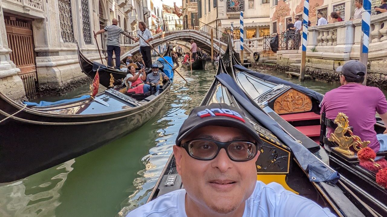 Guy taking selfie on a gondola in Venice