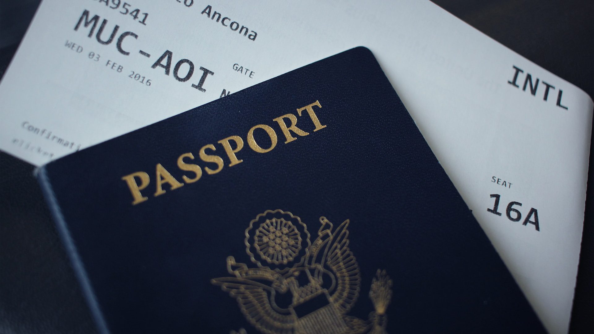 Close-up of blue passport and plane ticket