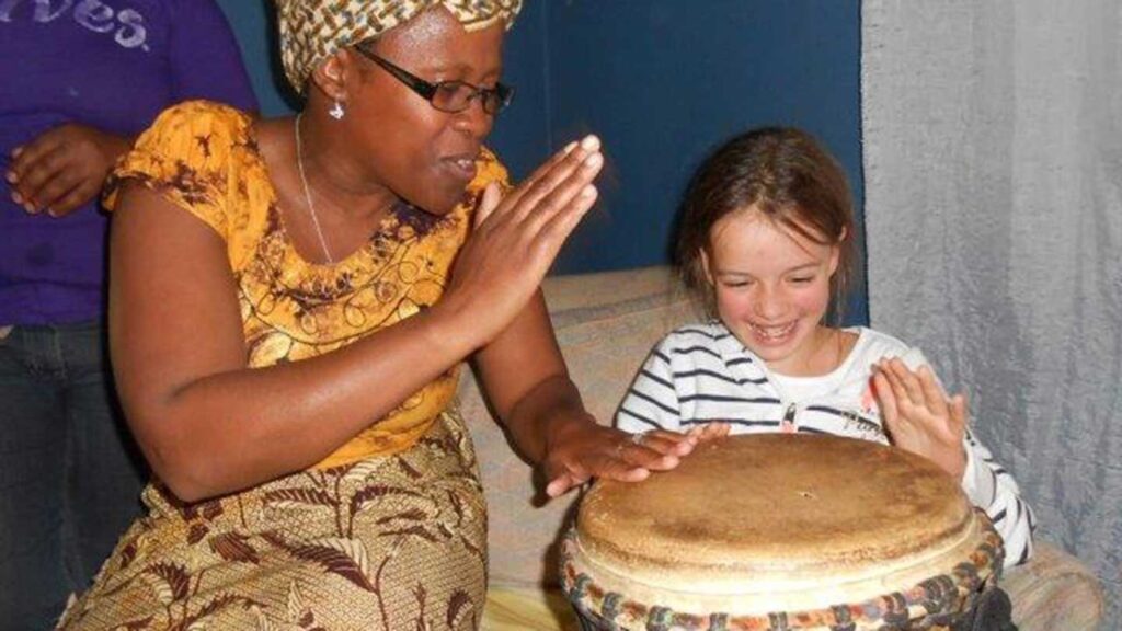 Be My Guest host Ella playing music with a young guest