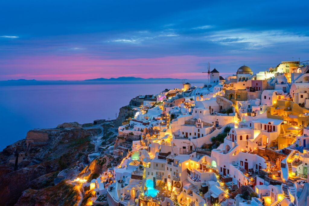 illuminated whitewashed buildings in Santorini Greece