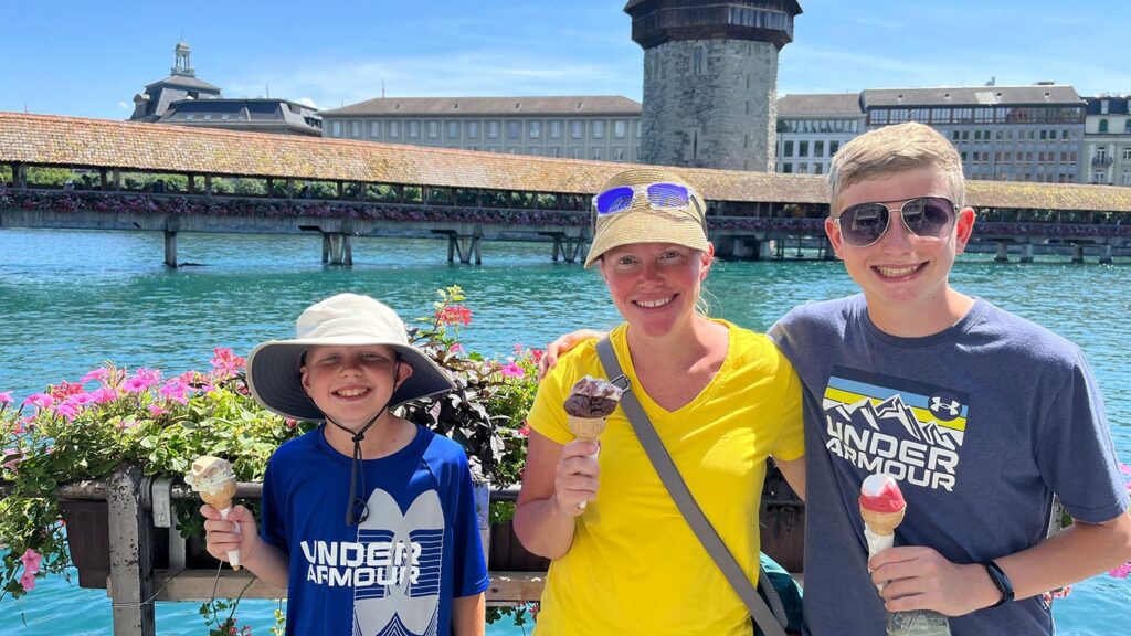 David's wife and two ons photographed holding ice creams in front of a lake