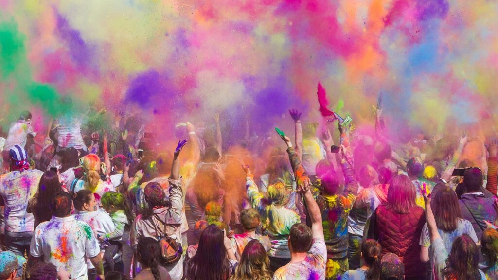 A modern crowd at a festival outside India with Holi colors