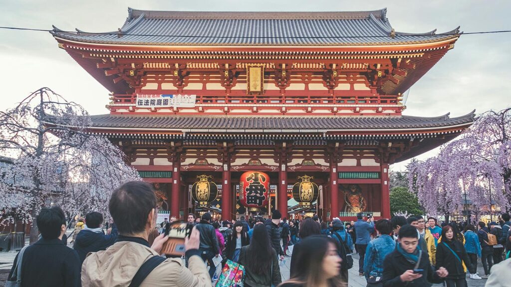 Crowds in front of a beautiful old temple in Japan