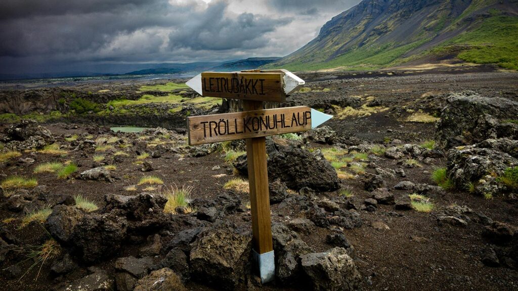Wooden signpost in the middle of a volcanic landscape in Iceland