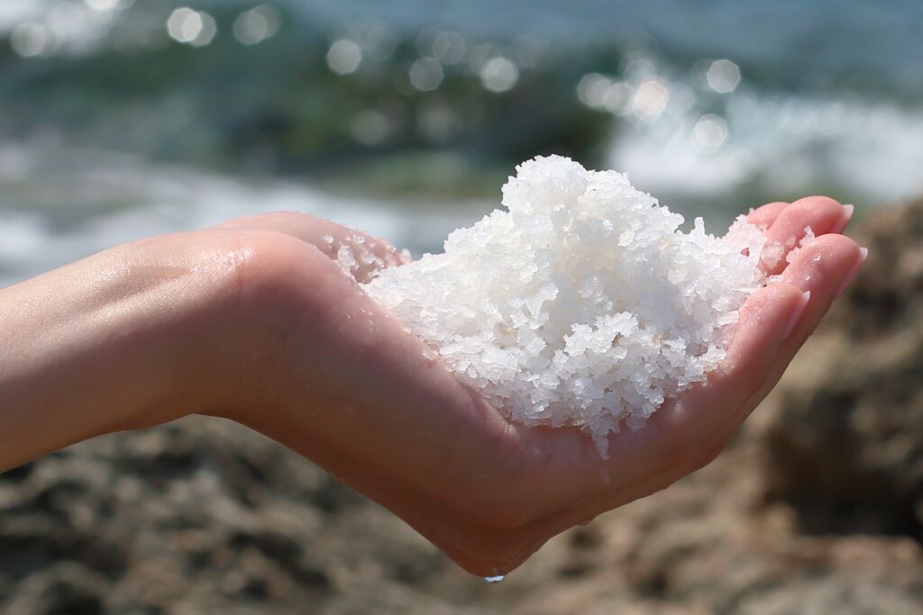 salt in hand on salt farm