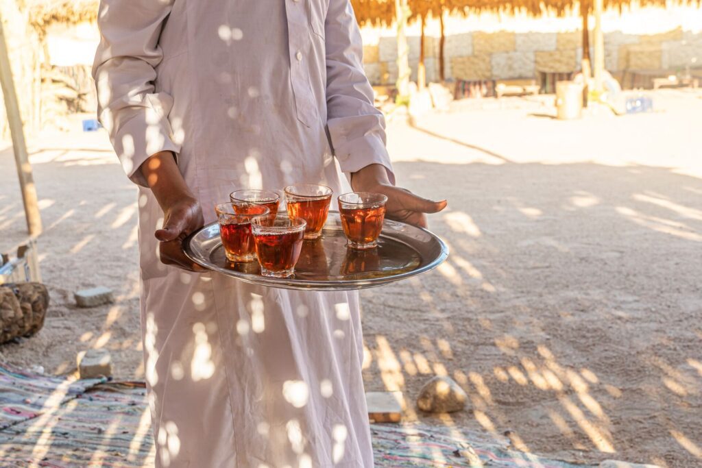 man holding tray of drinks