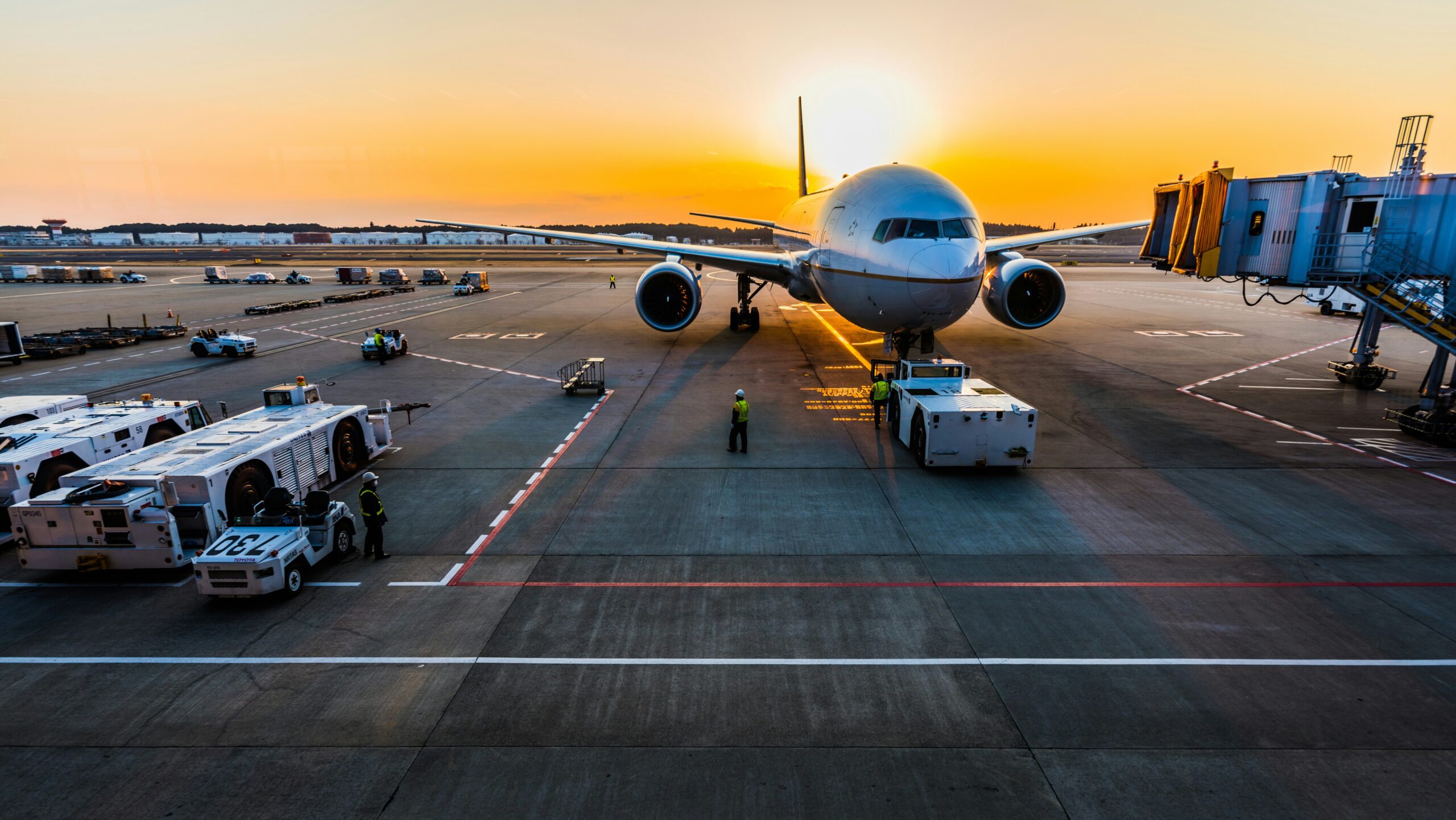 airplane on tarmac at sunrise