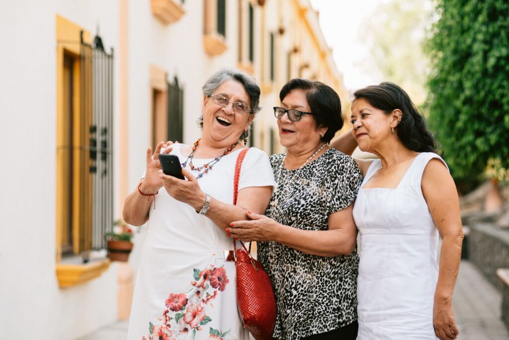 three women looking at a phone