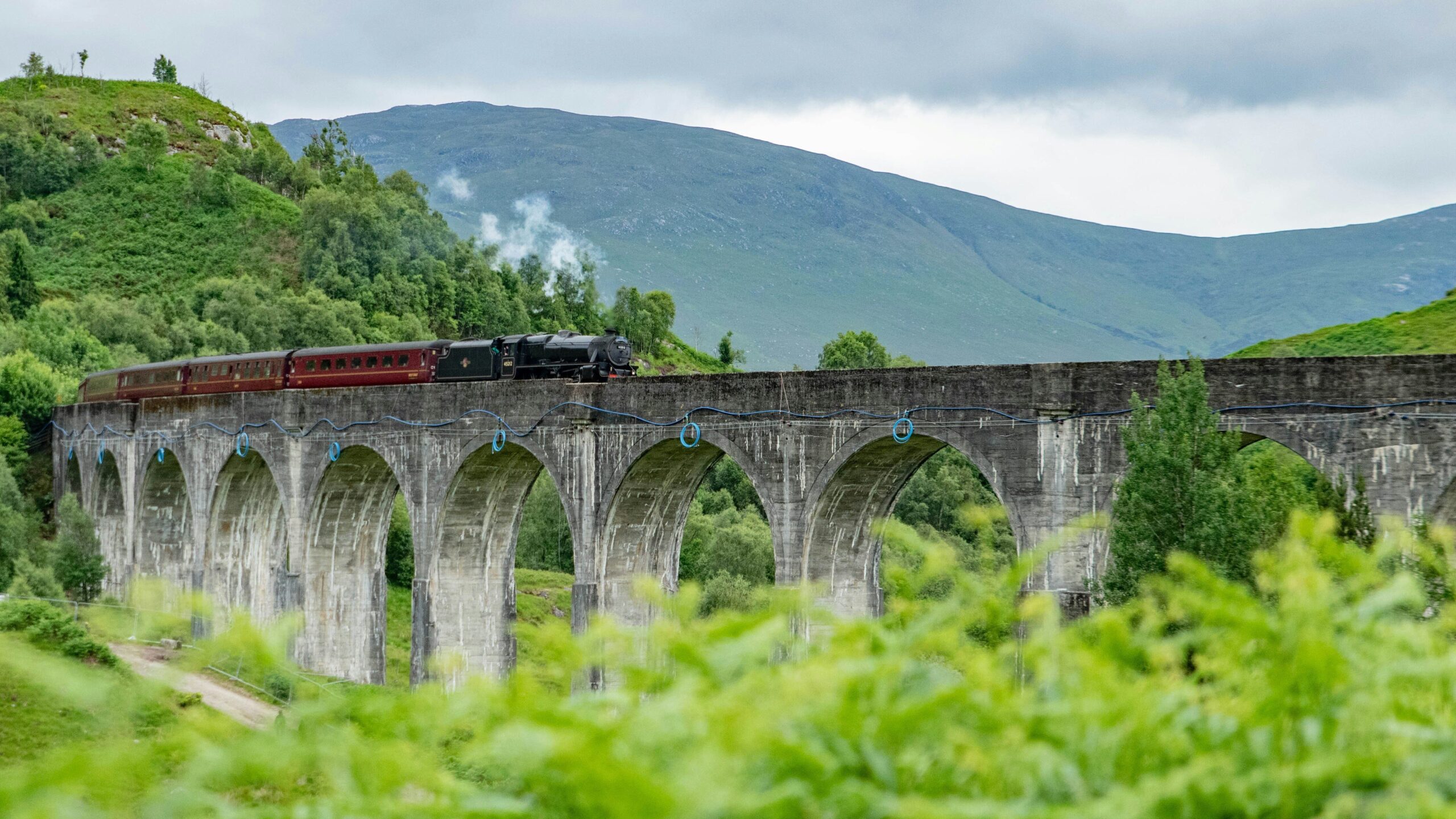 Steam train crossing Glenfinnan Viaduct